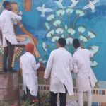 Students of Faculty of Archeology decorate two murals at the airport entrance, on Sahari road