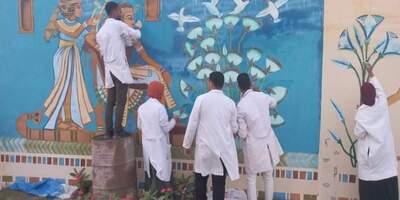 Students of Faculty of Archeology decorate two murals at the airport entrance, on Sahari road